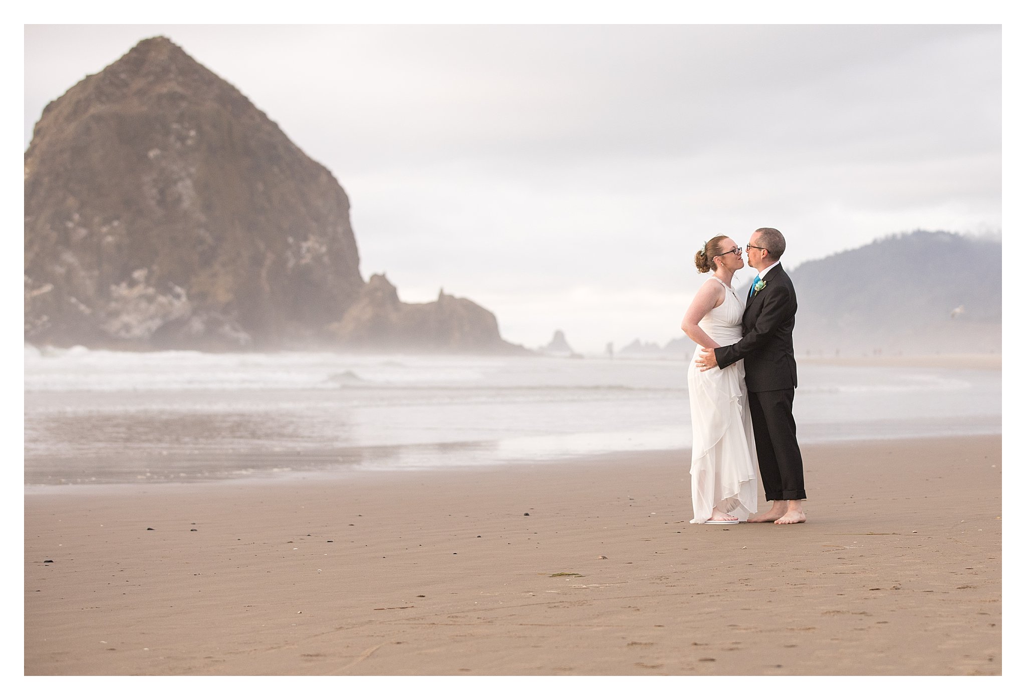 Wedding couple in front of haystack rock