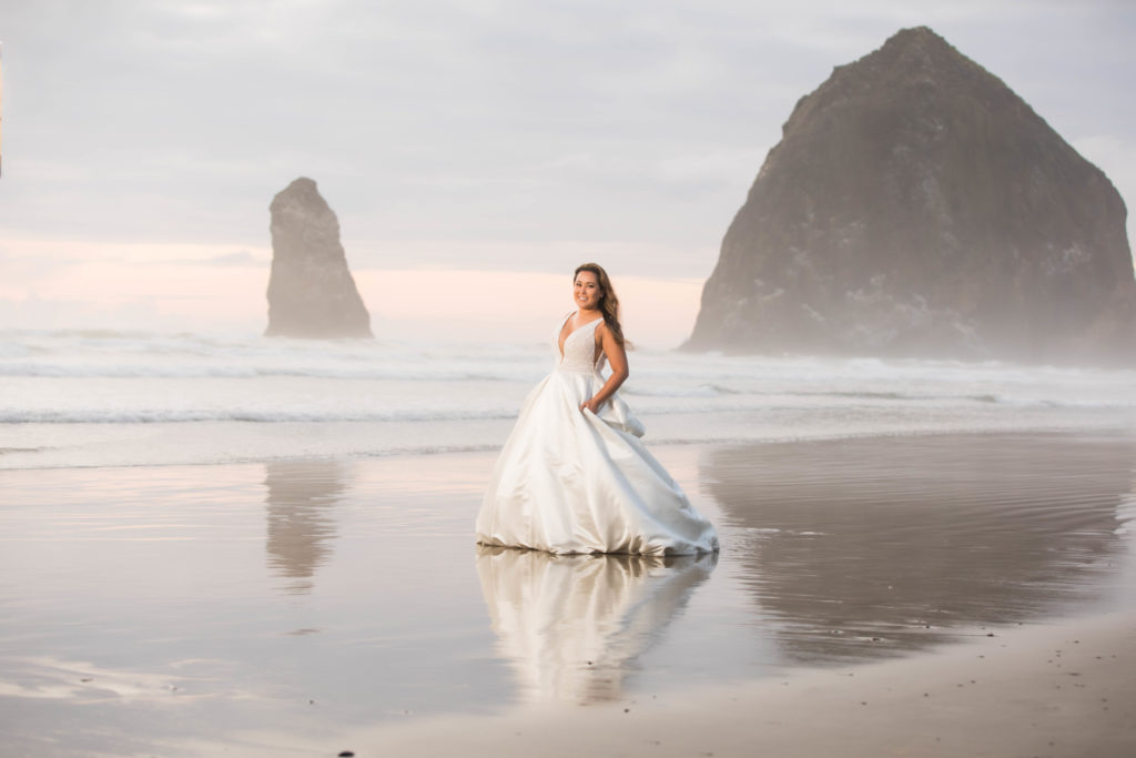 Bride in front of haystack rock  in Cannon beach, Oregon