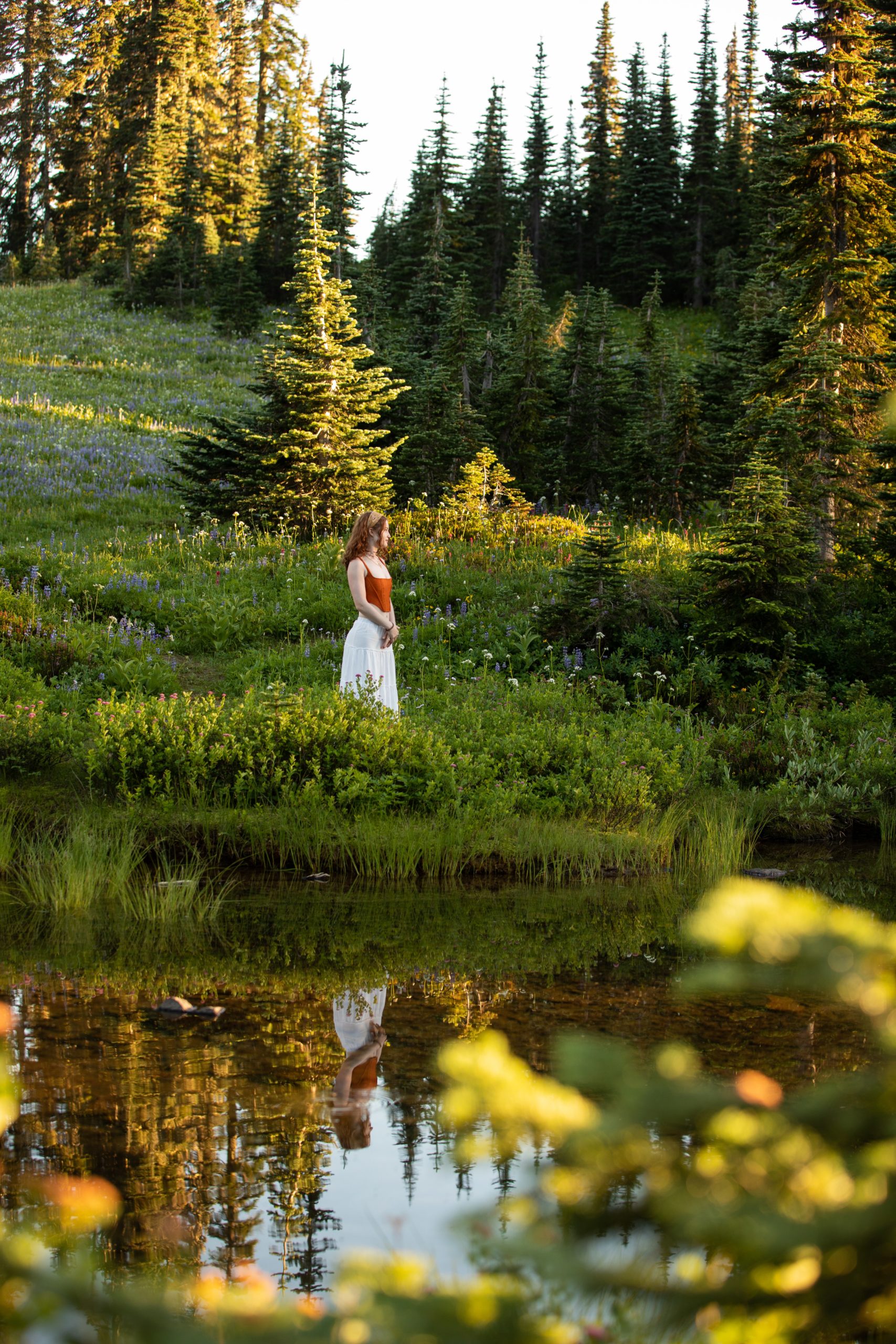 MOUNT RAINIER SENIOR PORTRAITS In the wild flowers at Mount Rainer Park.  Reflection in the lake. 